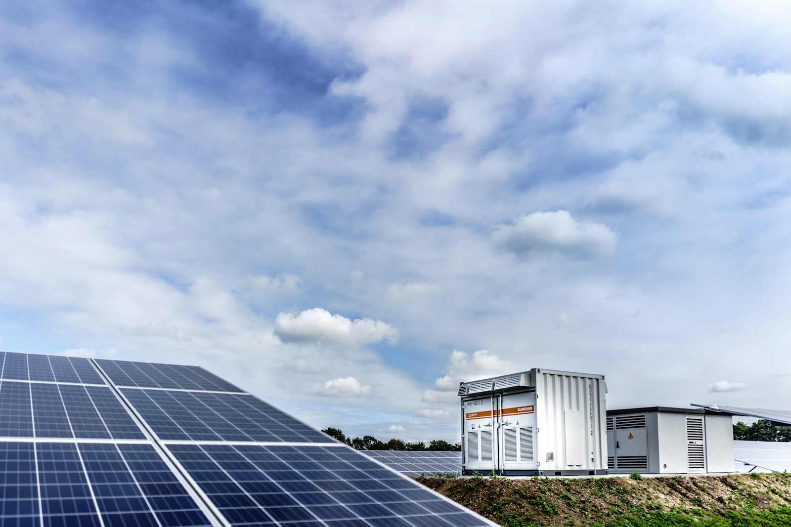 Battery energy storage cabinets beside a solar plant